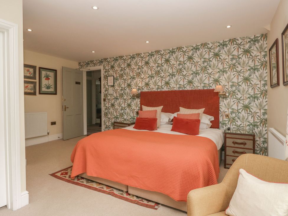 A bedroom with a bed and armchair at Shelley in Ambleside