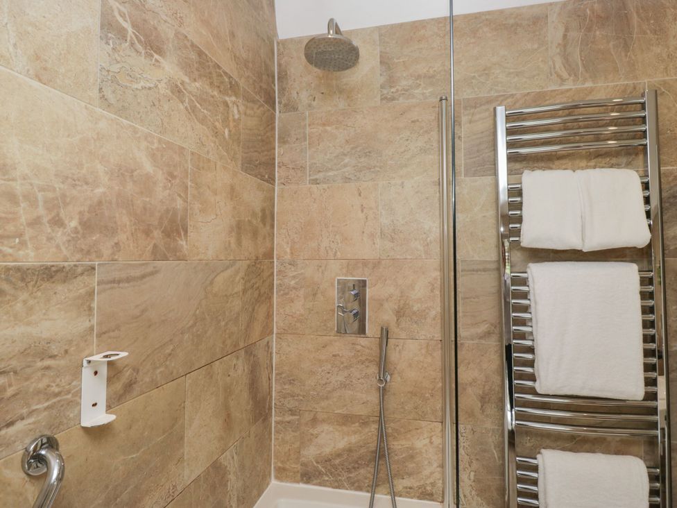 A bathroom with a shower and towel rack at Shelley in Ambleside