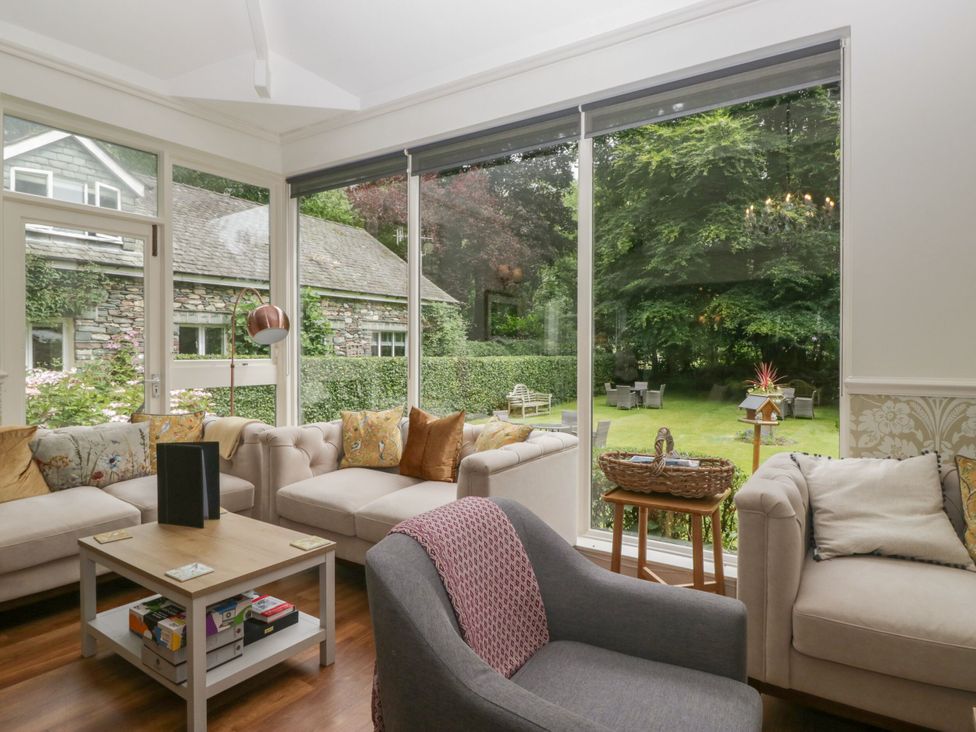 A living room with a view of the garden at Shelley in Ambleside