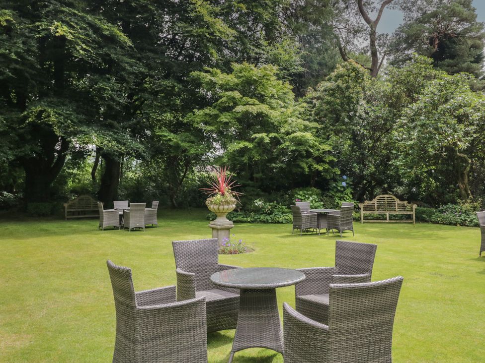 A garden with seating area and plants at Shelley in Ambleside