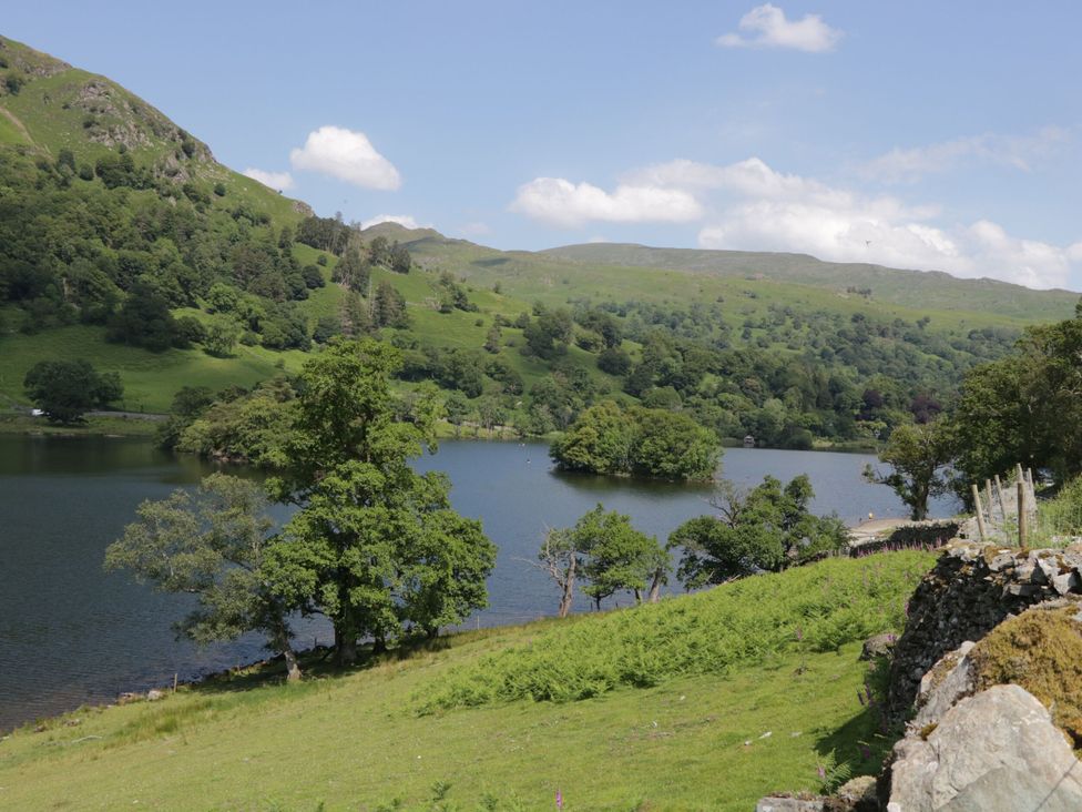 A lake surrounded by trees and hills at Shelley in Ambleside