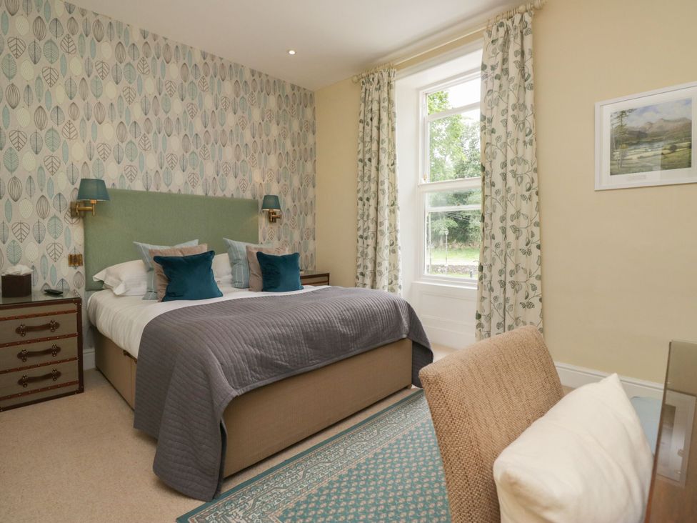 A bedroom with a bed and decorative elements at Coleridge in Ambleside