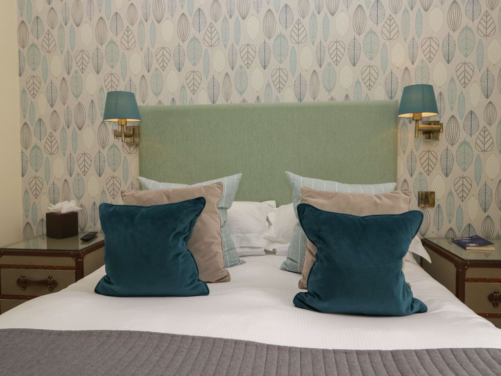 A bedroom with a bed and pillows at Coleridge in Ambleside