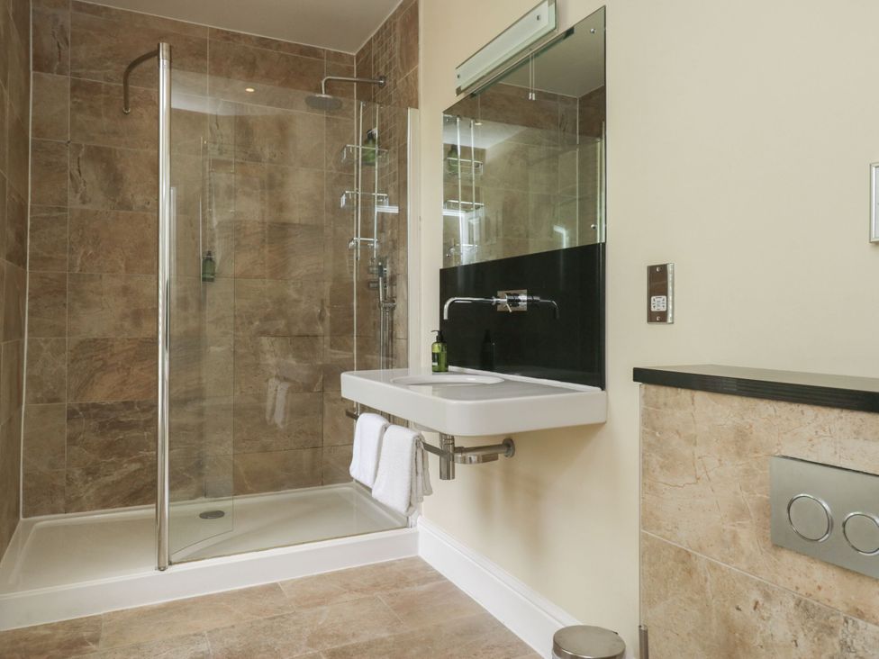 A bathroom with a shower and sink at Coleridge in Ambleside