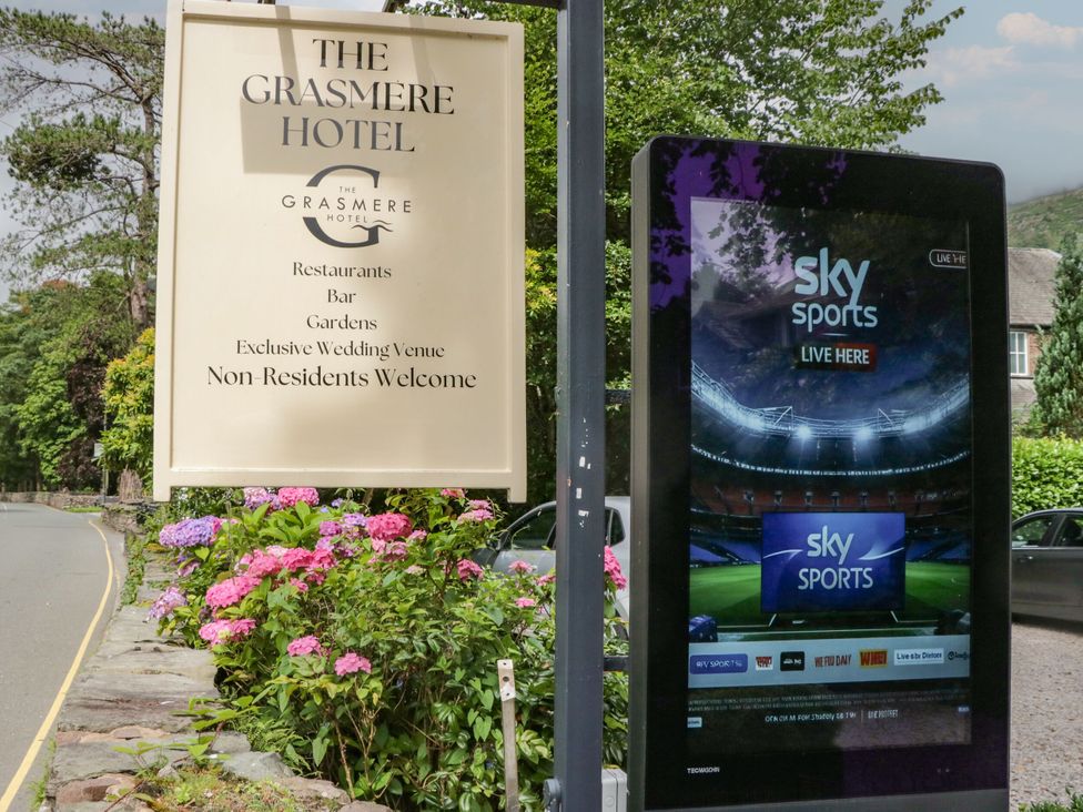 A hotel sign and digital screen at The Grasmere Hotel in Ambleside