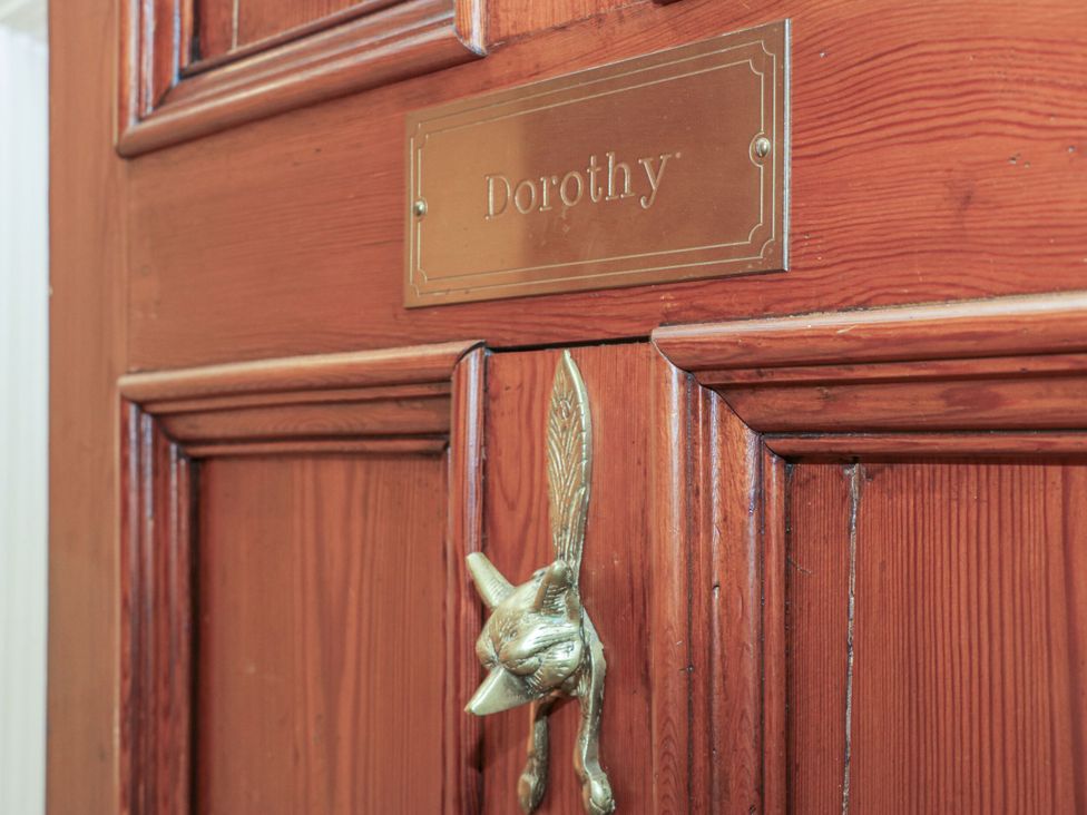 A door with a nameplate reading Dorothy and a decorative knocker at Dorothy in Ambleside
