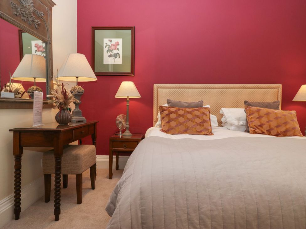 A bedroom with a bed and bedside tables at Dorothy in Ambleside