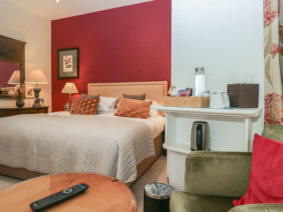 A bedroom with a bed and furniture at Dorothy in Ambleside