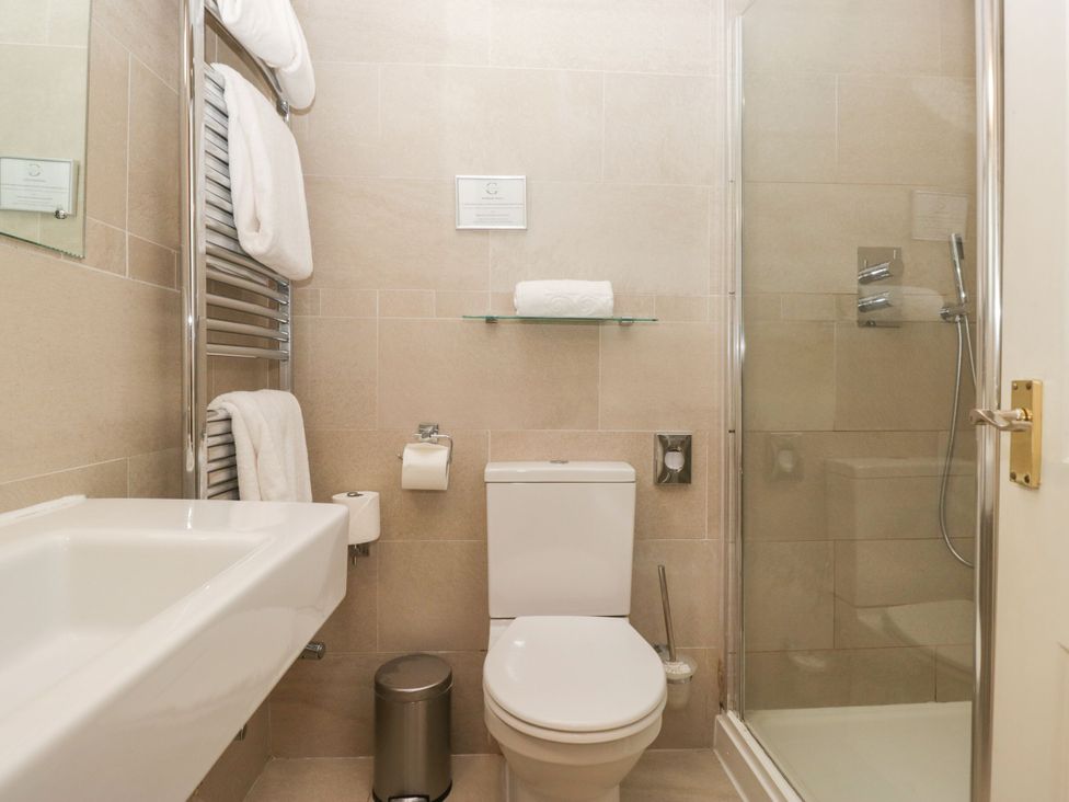 A bathroom with a shower, toilet, and sink at Dorothy in Ambleside
