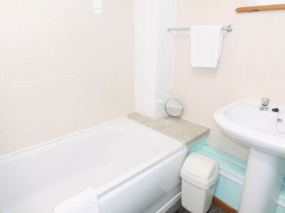 A bathroom with a bathtub and sink at The Old Barn in Manchester