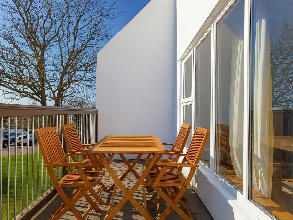 A balcony with a table and chairs at 21 Tamar & St. Anns Cottages Honicombe Park near St. Ann's Chapel, Cornwall