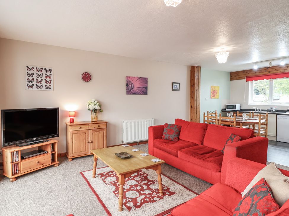 A living room with a television and sofa at 21 Tamar & St. Anns Cottages Honicombe Park near St. Ann's Chapel, Cornwall