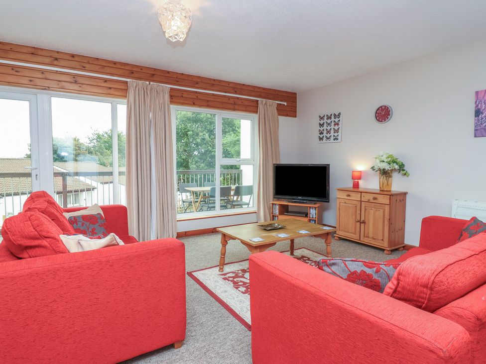 A living room with sofas and a television at 21 Tamar & St. Anns Cottages, Honicombe Park near St. Ann's Chapel, Cornwall