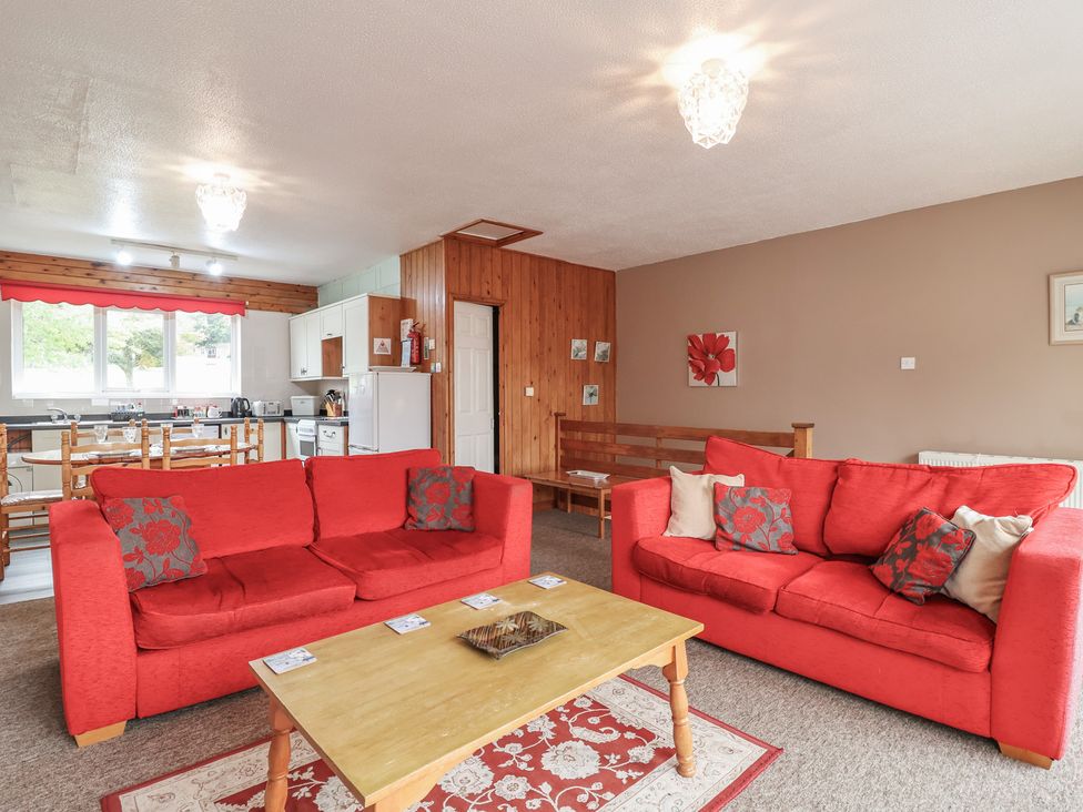 A living room with sofas and a dining area at 21 Tamar & St. Anns Cottages near Honicombe Park near St. Ann's Chapel, Cornwall
