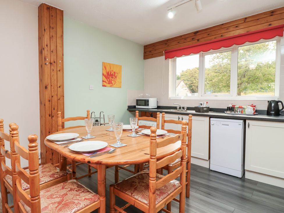 A kitchen with a dining table and chairs at 21 Tamar & St. Anns Cottages, Honicombe Park near St. Ann's Chapel, Cornwall