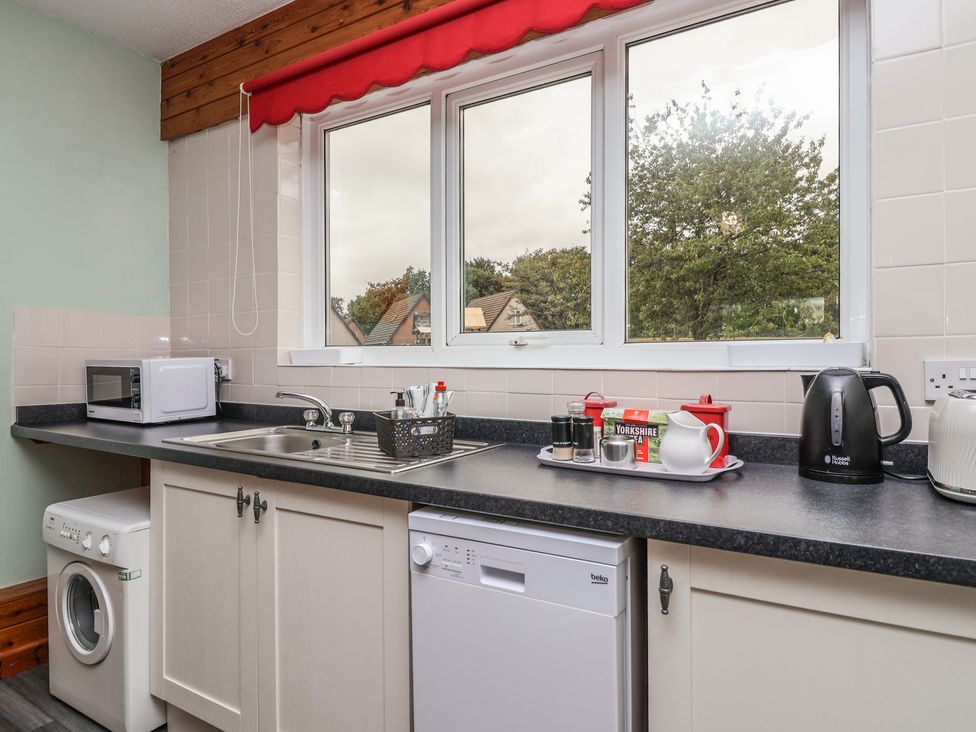 A kitchen with a sink and appliances at 21 Tamar & St. Anns Cottages Honicombe Park near St. Ann's Chapel, Cornwall