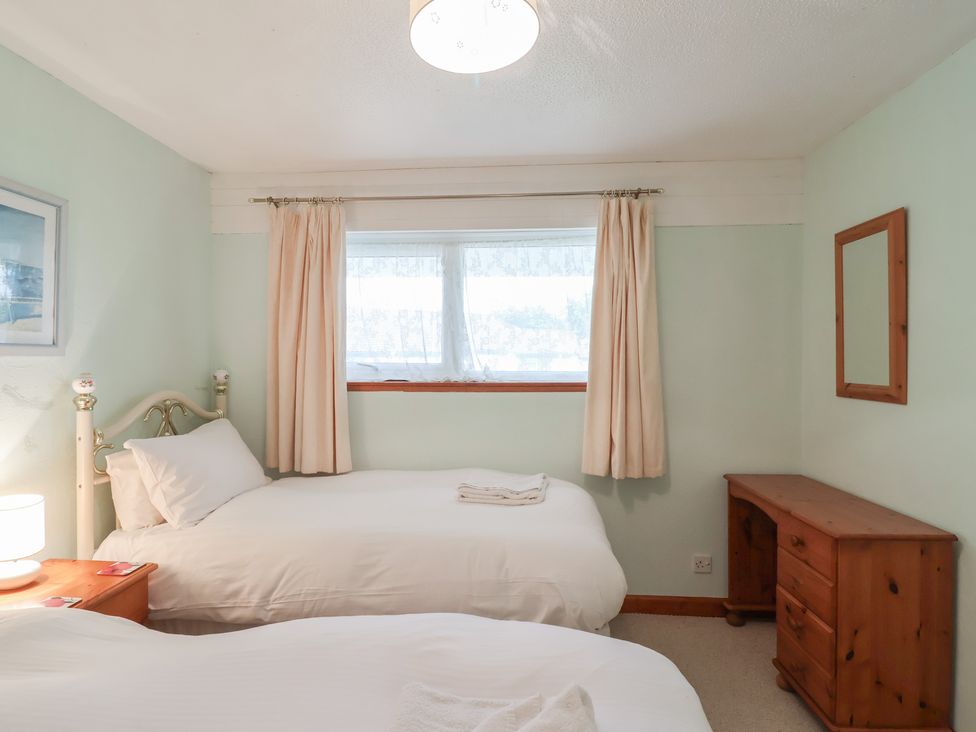 A bedroom with two beds and a dresser at 21 Tamar & St. Anns Cottages, Honicombe Park near St. Ann's Chapel, Cornwall