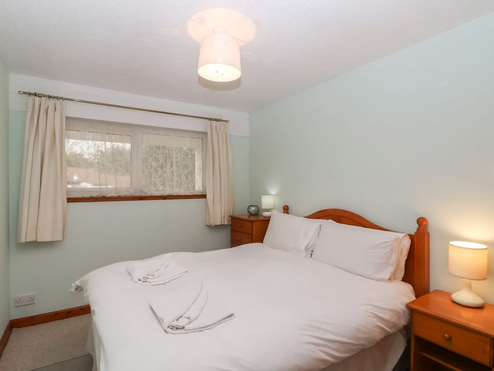 A bedroom with a bed and bedside tables at 21 Tamar & St. Anns Cottages Honicombe Park near St. Ann's Chapel, Cornwall