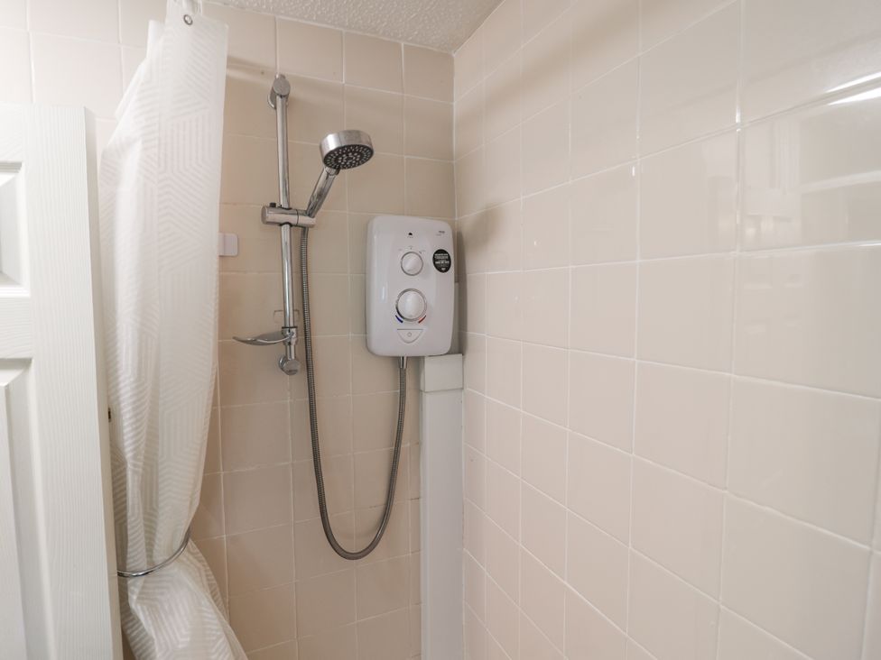 A shower with a shower head and control in the bathroom at 21 Tamar & St. Anns Cottages Honicombe Park near St. Ann's Chapel, Cornwall