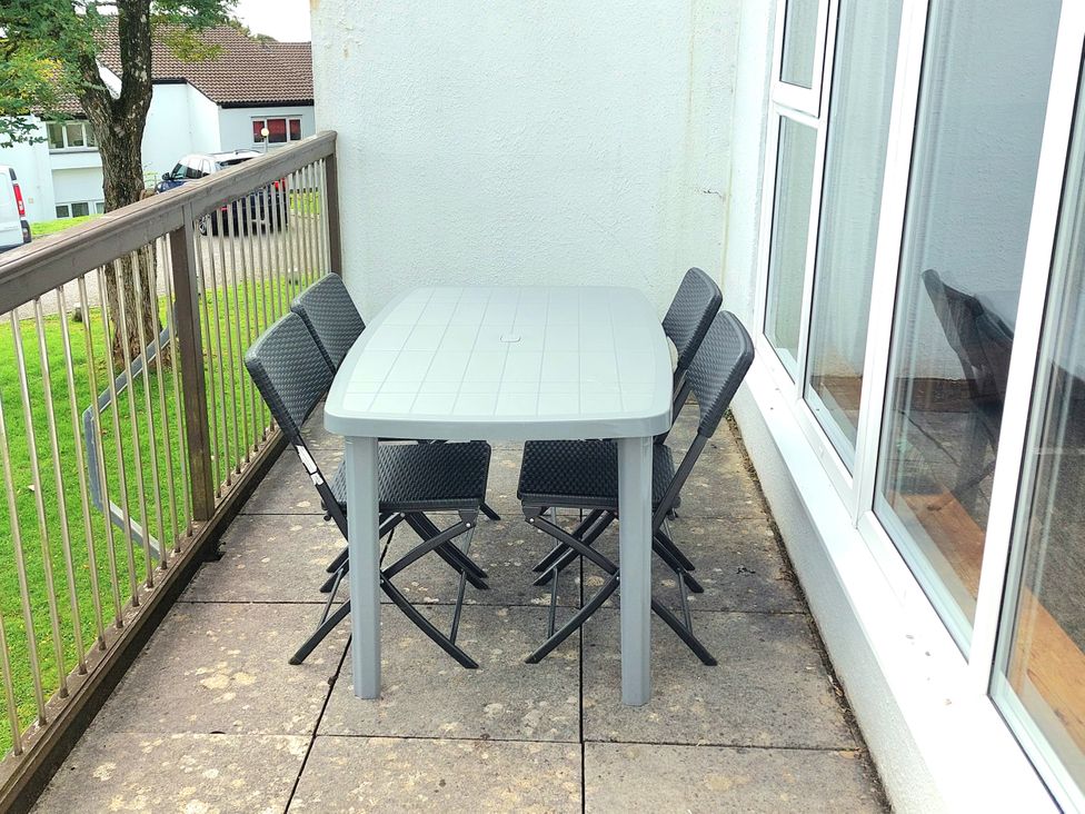 An outdoor seating area with a table and chairs at 21 Tamar & St. Anns Cottages Honicombe Park near St. Ann's Chapel, Cornwall