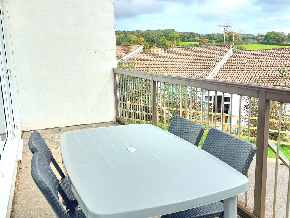 A balcony with a table and chairs at 21 Tamar & St. Anns Cottages Honicombe Park near St. Ann's Chapel, Cornwall