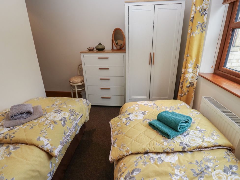 A bedroom with two beds and a wardrobe at Green Route Apartment