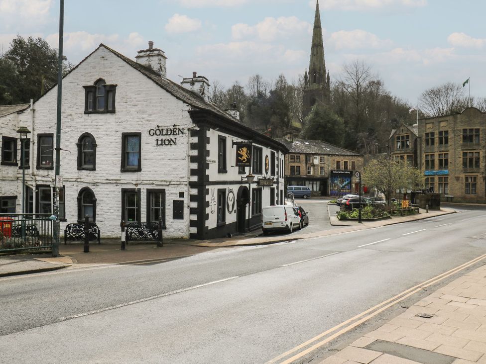An outdoor view of a pub and street at Green Route Apartment in Todmorden