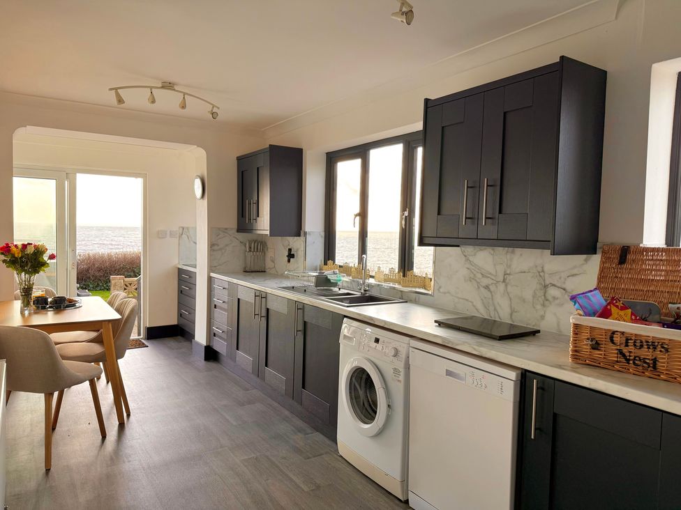 A kitchen with cabinets and appliances at Crows Nest Dawlish