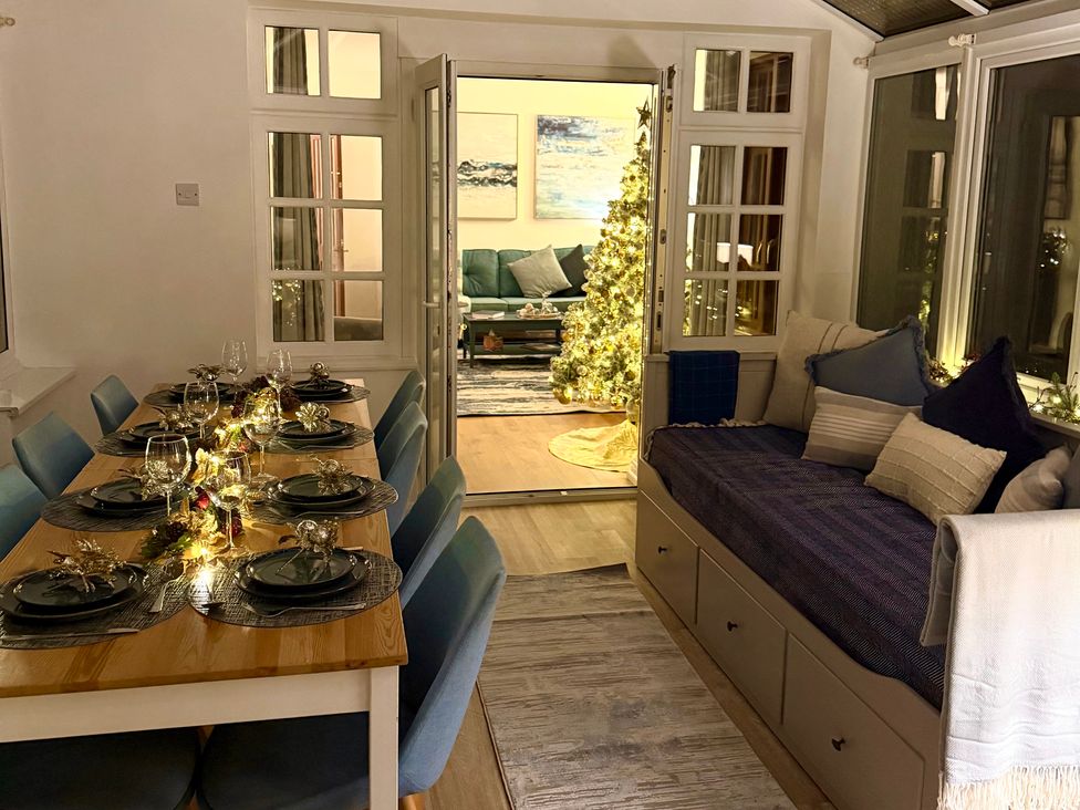 A dining room with a table and chairs at Crows Nest Dawlish