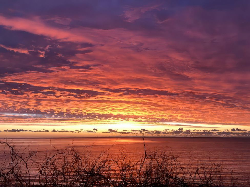 A sunset over the ocean with clouds at Crows Nest Dawlish in Dawlish