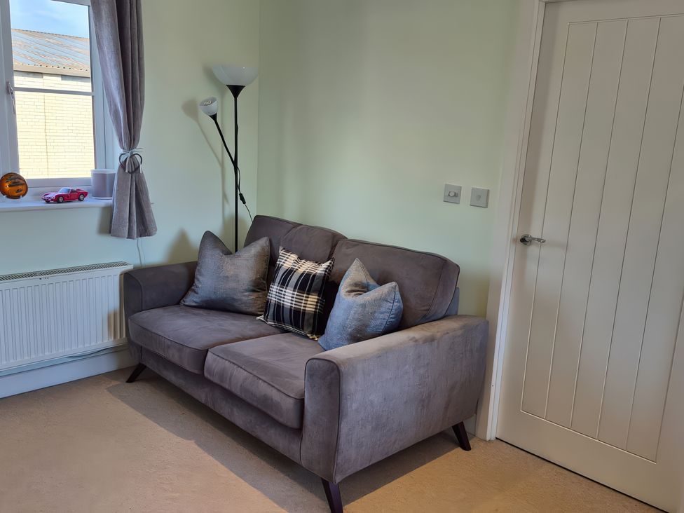 A living room with a sofa and pillows at 54 swallow road