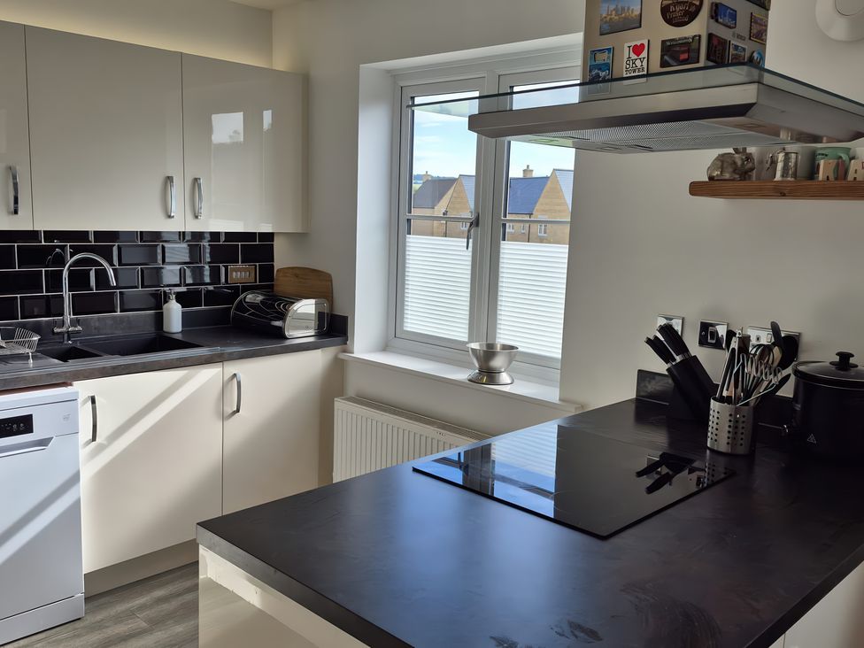 A kitchen with a sink, dishwasher, and stove at 54 swallow road