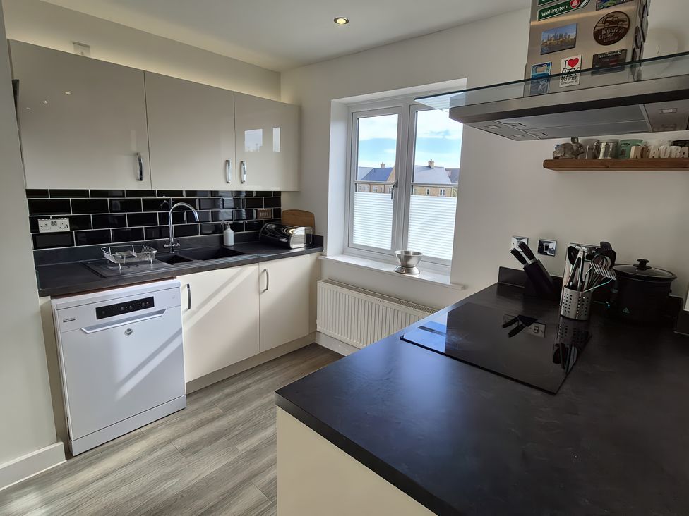 A kitchen with modern appliances and a window at 54 swallow road