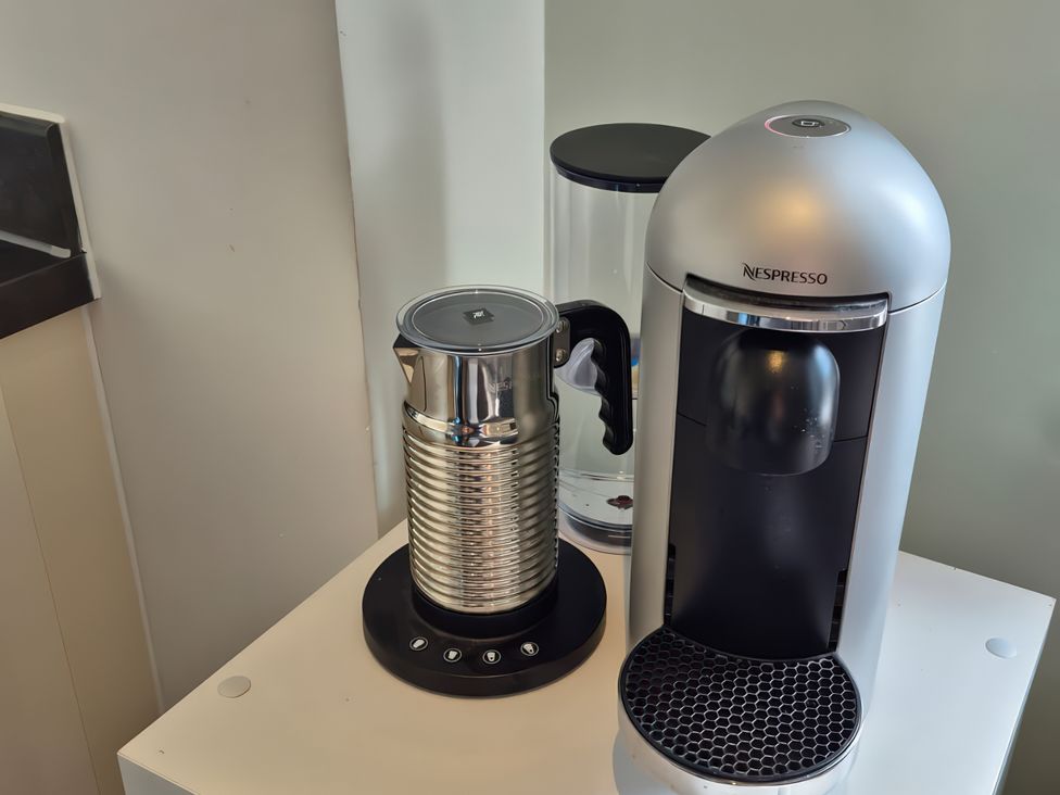 A coffee maker and milk frother on a counter at 54 swallow road