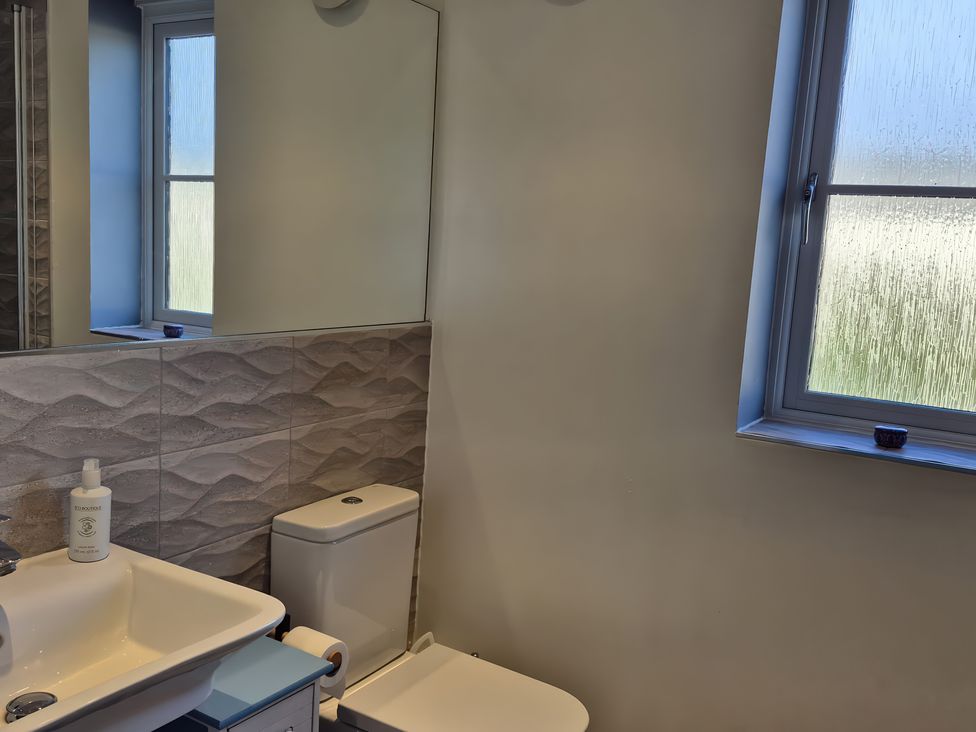A bathroom with sink, toilet and window at 54 swallow road