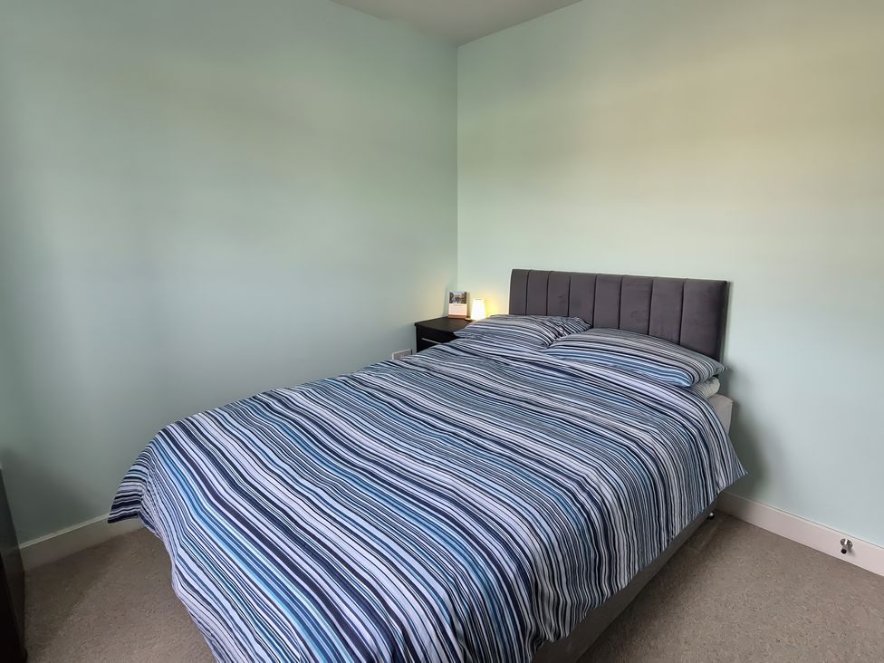 A bedroom with a bed and nightstand at 54 swallow road