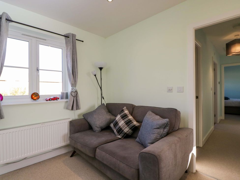 A living room with a sofa and window at Swallows Nest in Bourton-On-The-Water