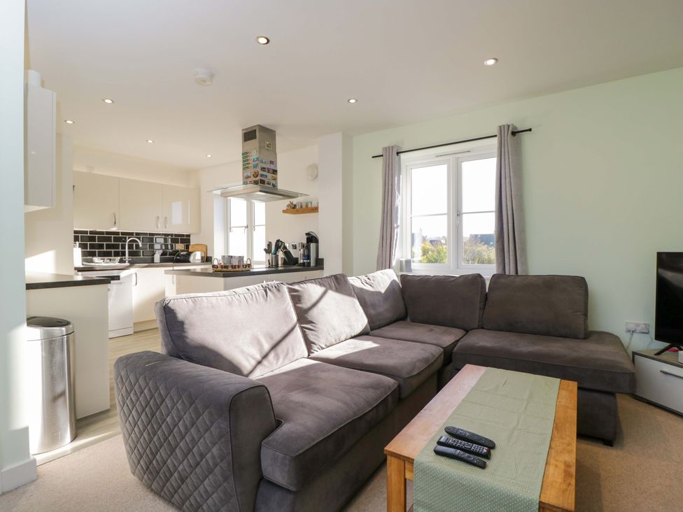 A living room with a couch and coffee table at Swallows Nest in Bourton-On-The-Water