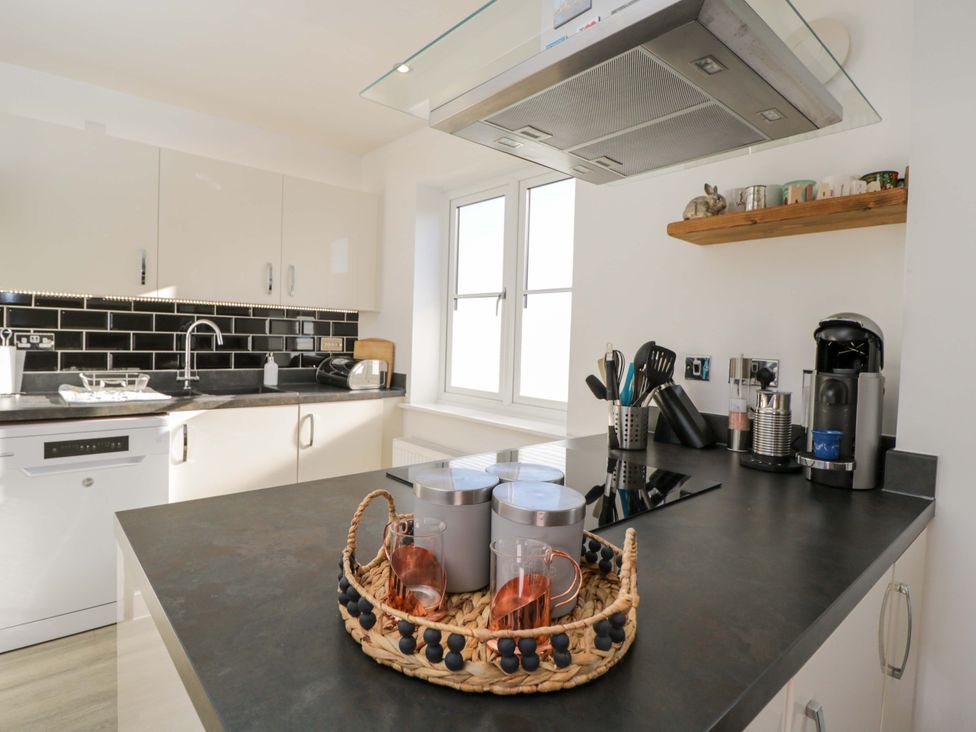 A kitchen with a sink and appliances at Swallows Nest in Bourton-On-The-Water
