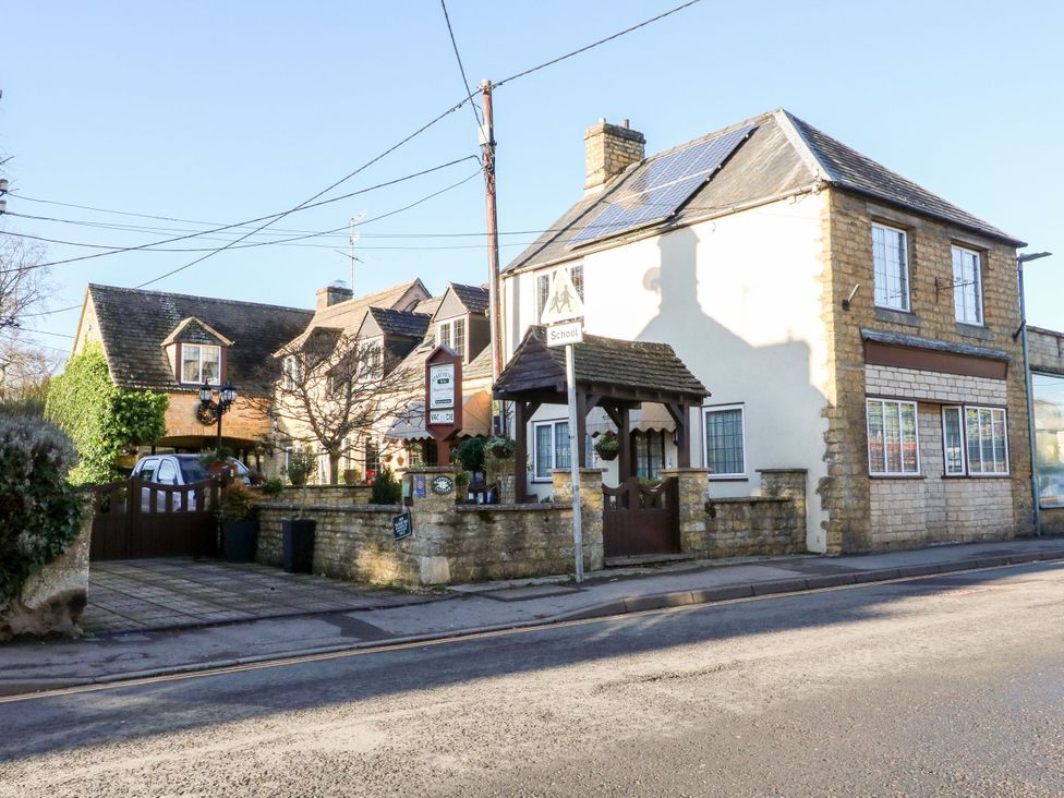 A building with a gate and sign at Swallows Nest in Bourton-On-The-Water
