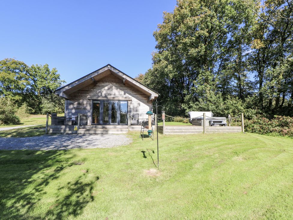 A house with a deck and surrounding grass at Cadno in Llanybydder