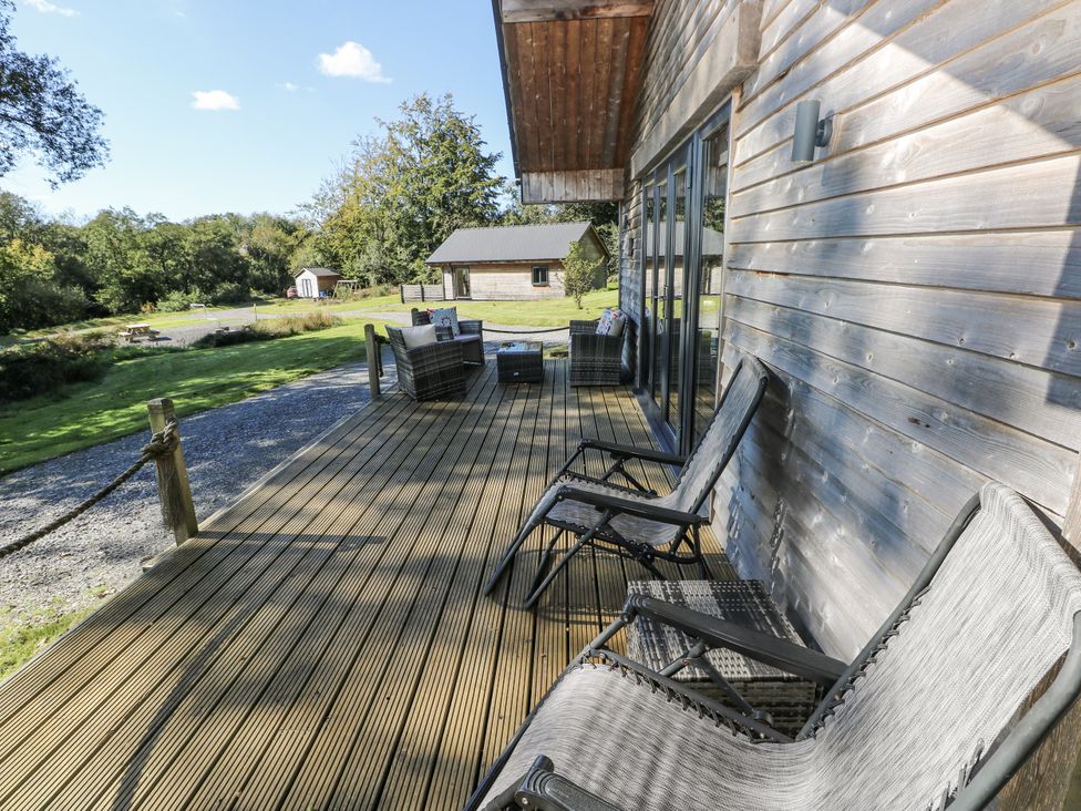 A deck area with chairs and table at Cadno Llanybydder