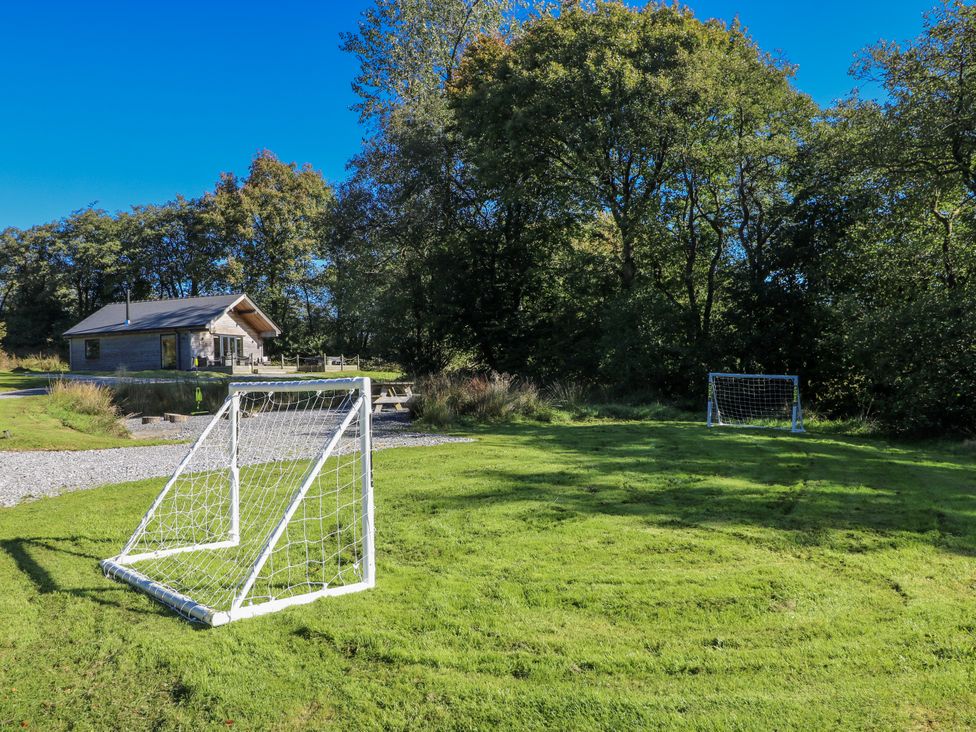 A cabin with soccer goals on a grassy field at Cadno in Llanybydder