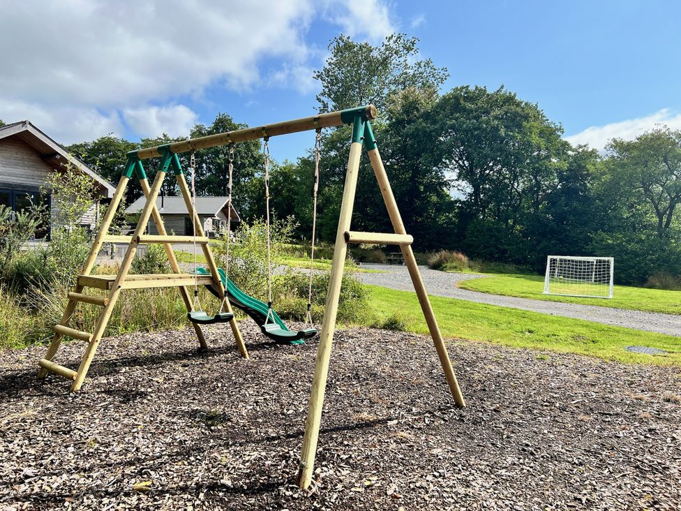 A playground with a swing set and soccer goal at Cadno Aber near Llanybydder