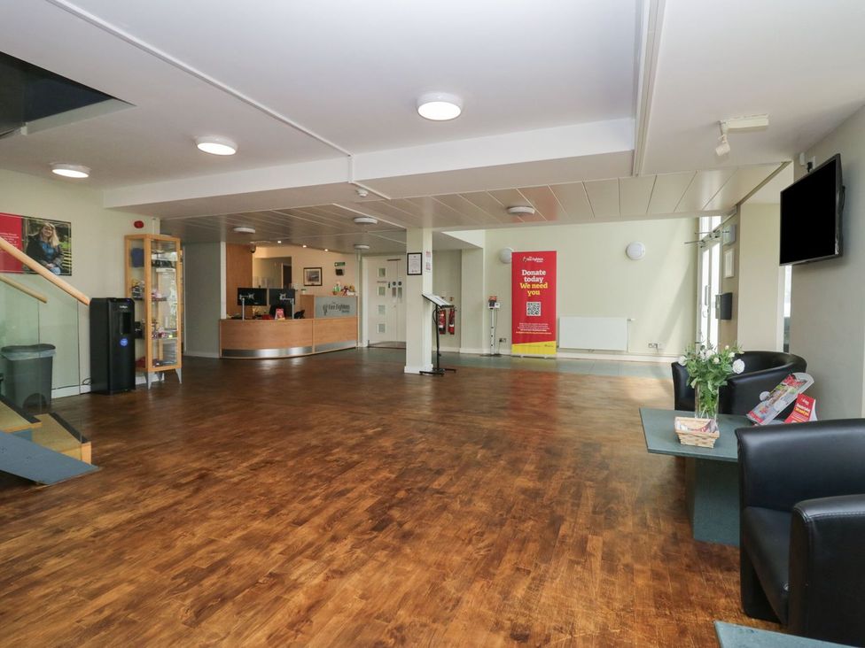 A lobby with a reception desk and seating area at Railway Retreat at Eamont Park Penrith