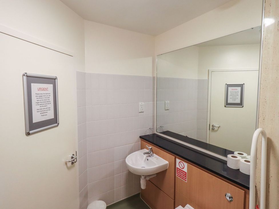 A bathroom with a sink and mirror at Thacka Beck Retreat at Eamont Park Penrith