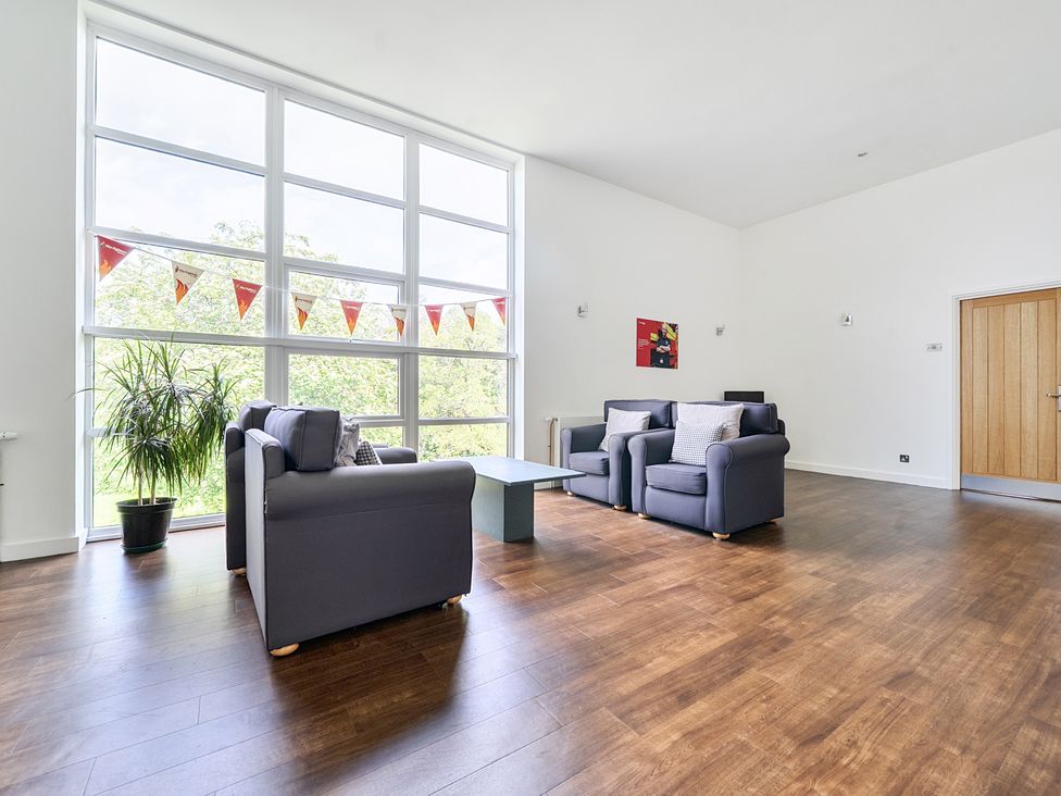 A living room with sofas and a table at Jubilee First-floor Single Bedroom in Penrith