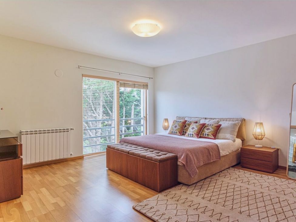 A bedroom with a bed and bedside table at 