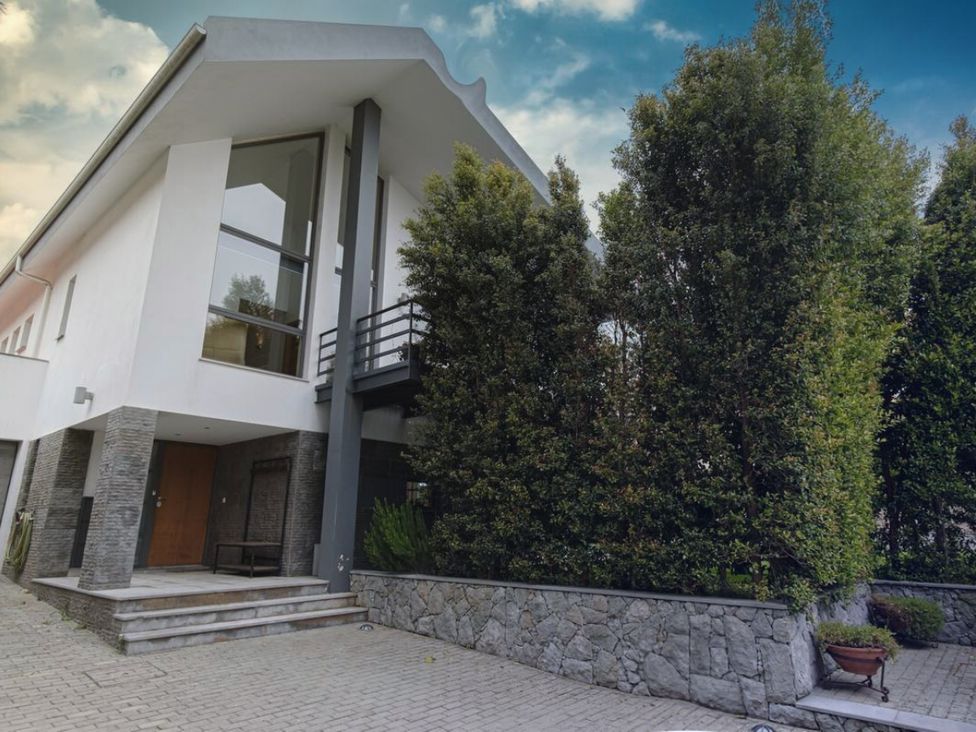 A house with steps and plants outside at unspecified location