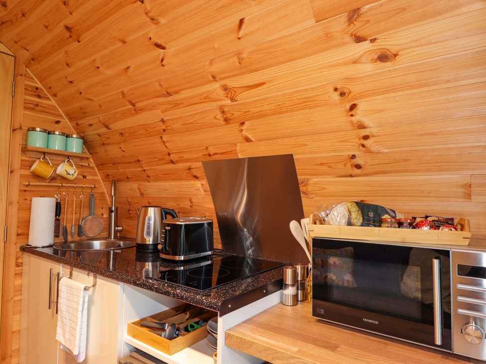 A kitchen with appliances and storage at The Pod at Greenbank Isle of Skye
